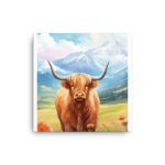 A Nicheink Highland Cow Canvas Wall Art | Rustic Farmhouse Decor of a highland cow in a field with mountains in the background.